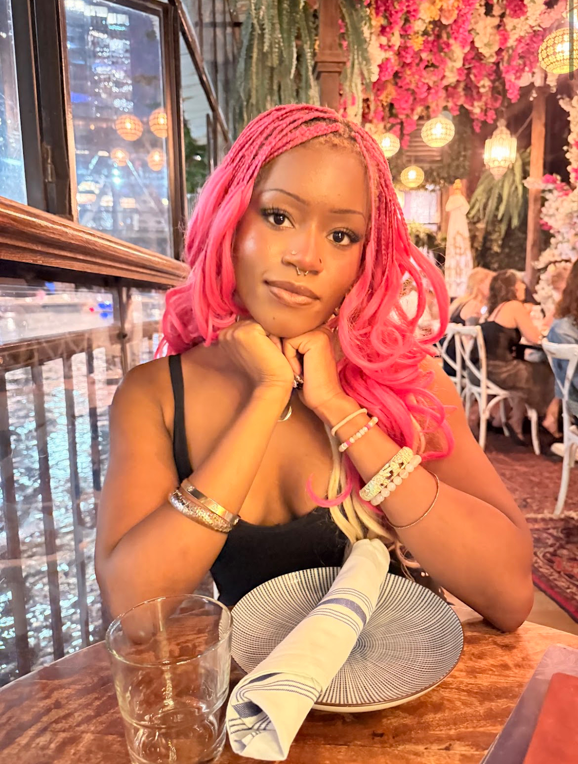 Client wearing long pink knotless braids styled at Gege Hair Salon